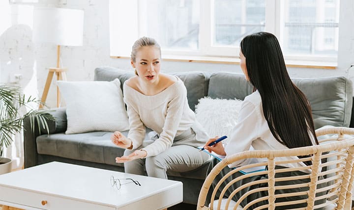 Therapist meets with patient in cozy office.