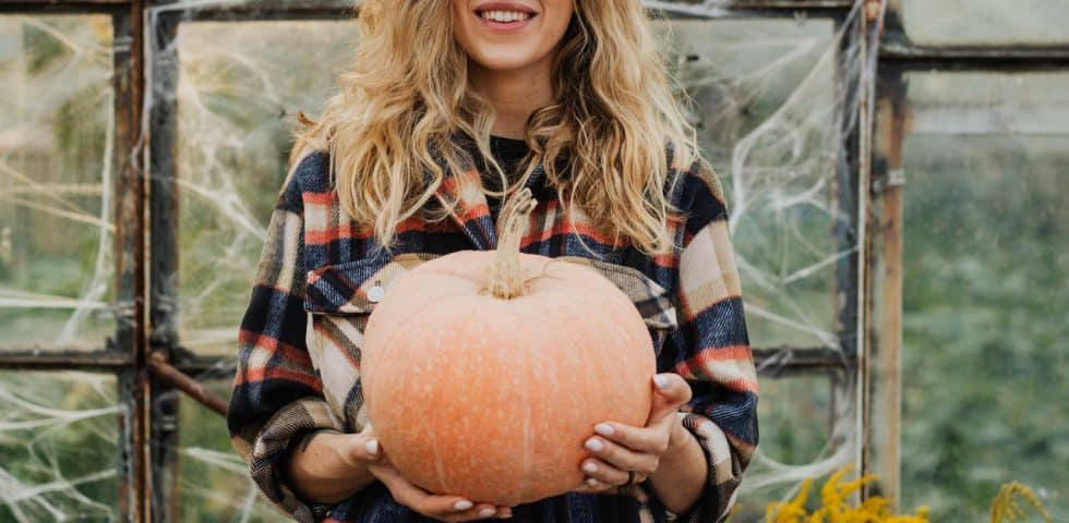 Woman holds a pumpkin