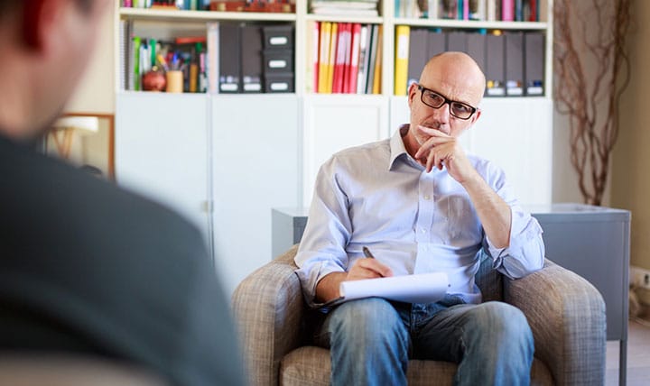 Therapist meets with patient in cozy office.